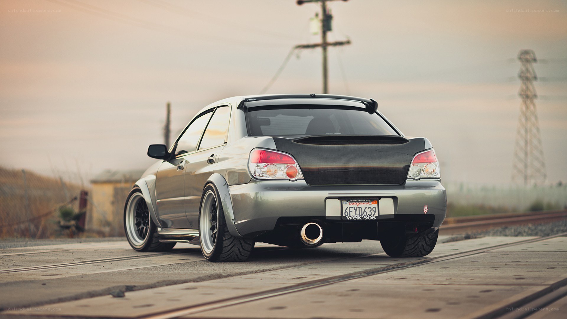 silver subaru on train tracks