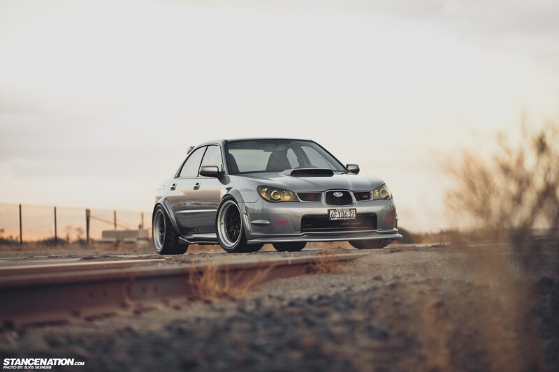 silver subaru on train tracks