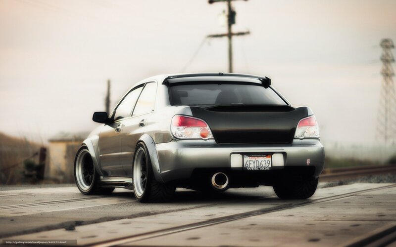 silver subaru on train tracks