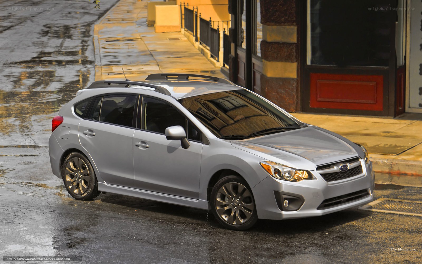 silver subaru on wet street
