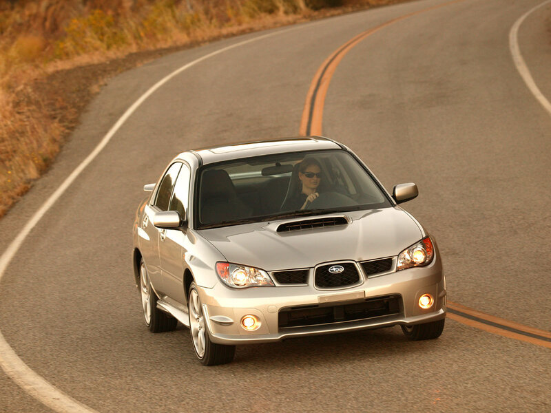 silver subaru on winding road