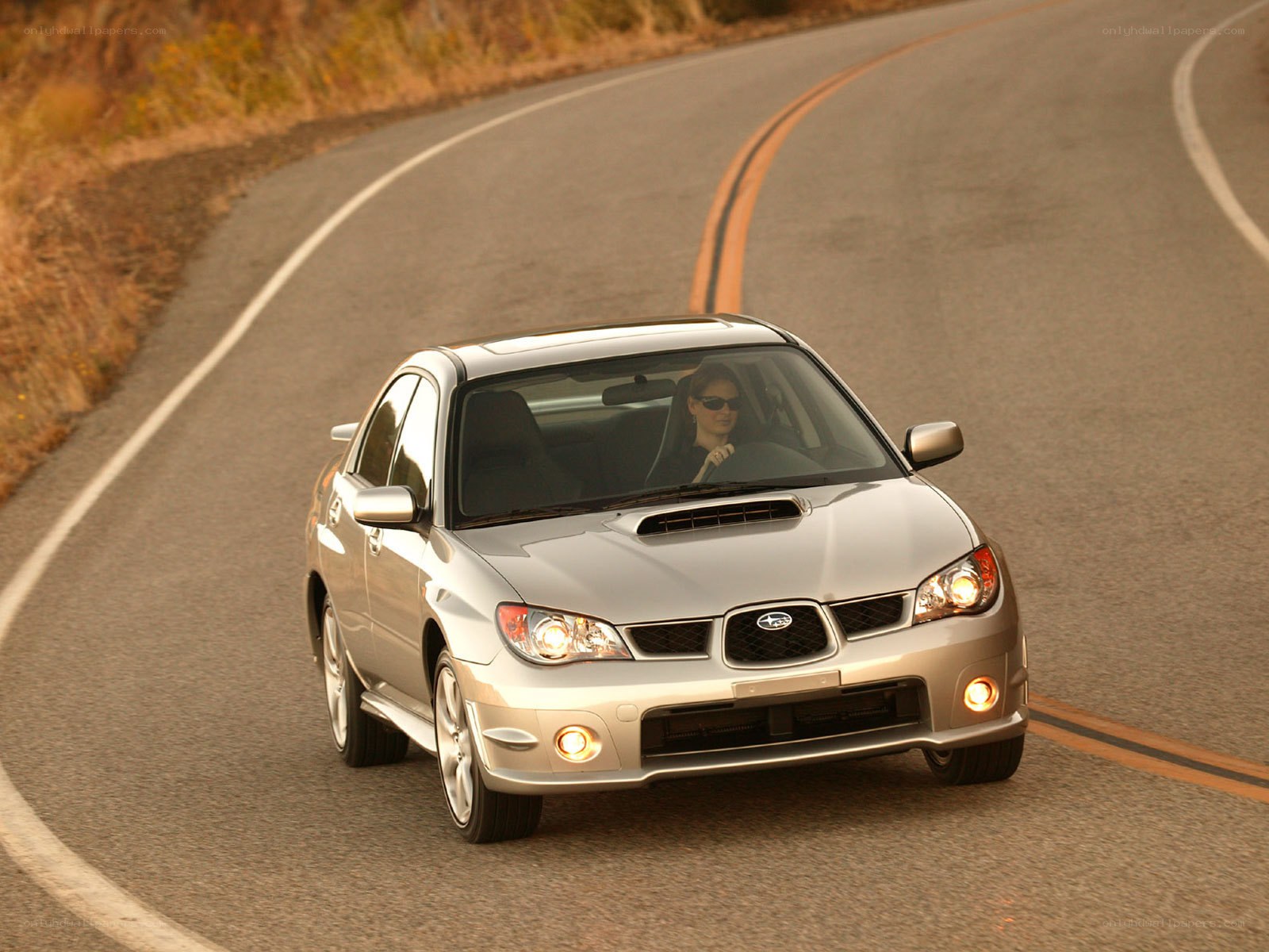 silver subaru on winding road