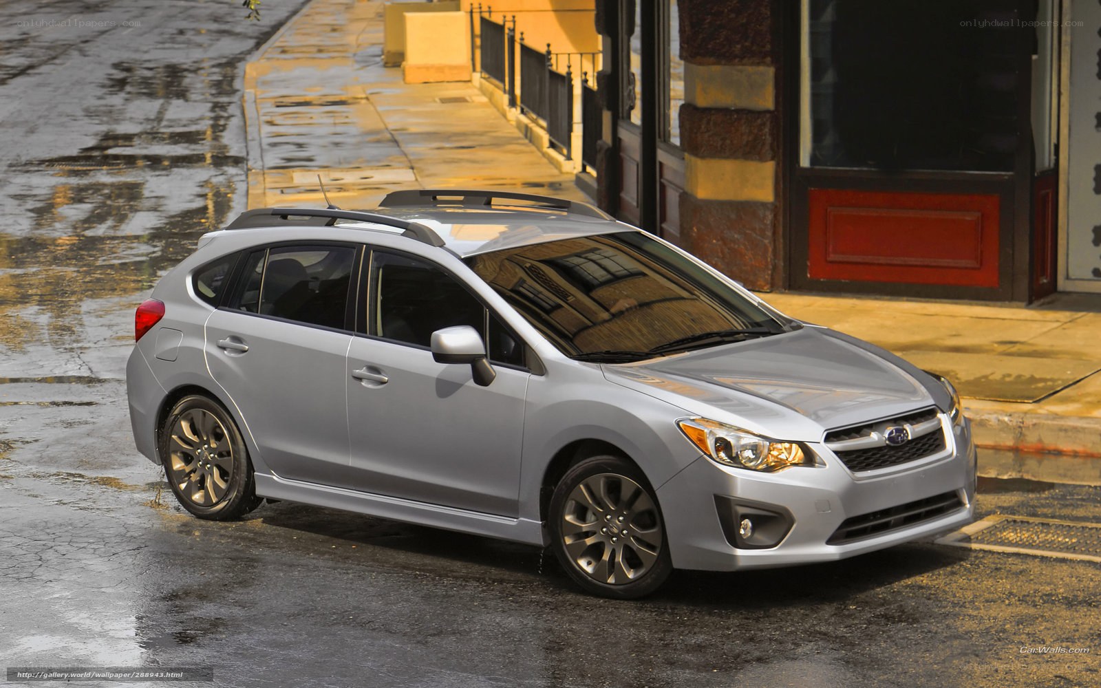 Silver Subaru parked on wet street