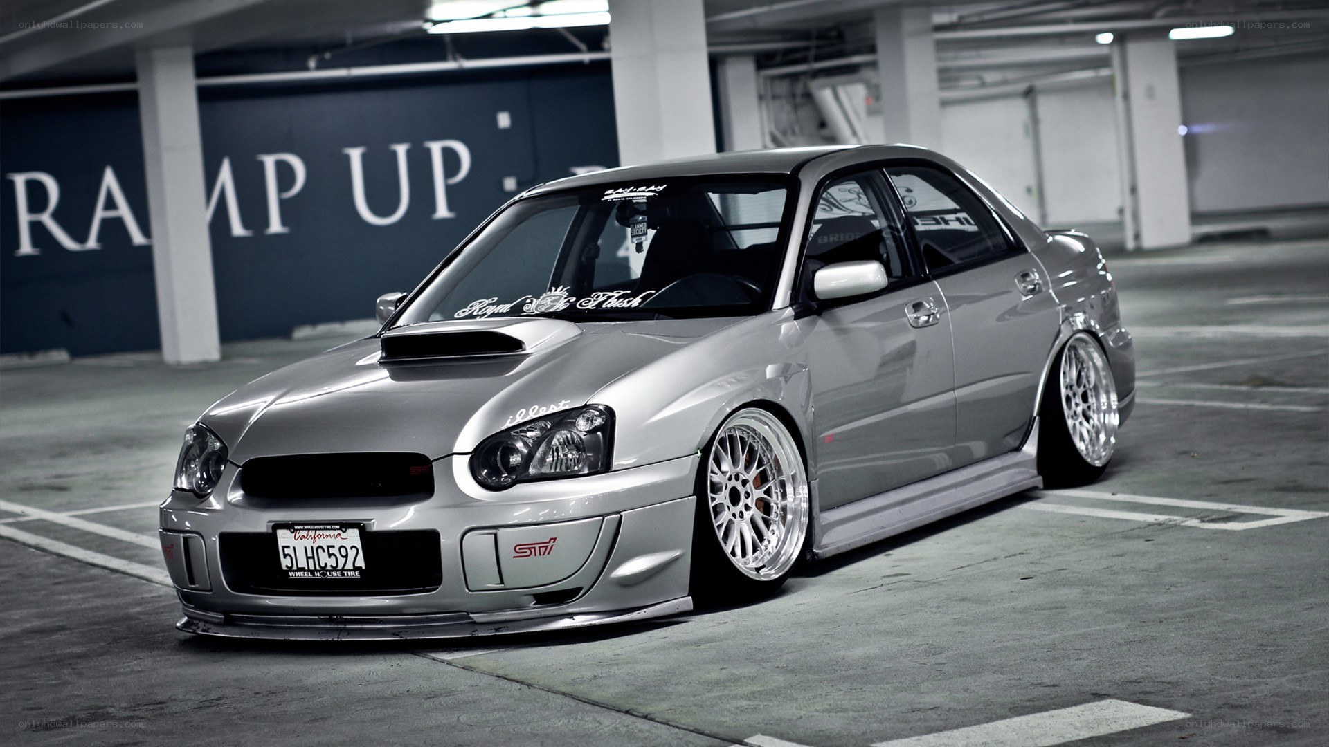 silver subaru sti in parking garage