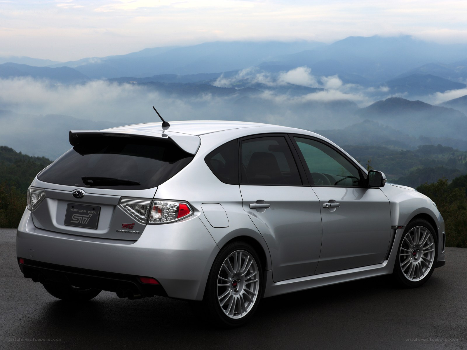 Silver Subaru STI on mountain road