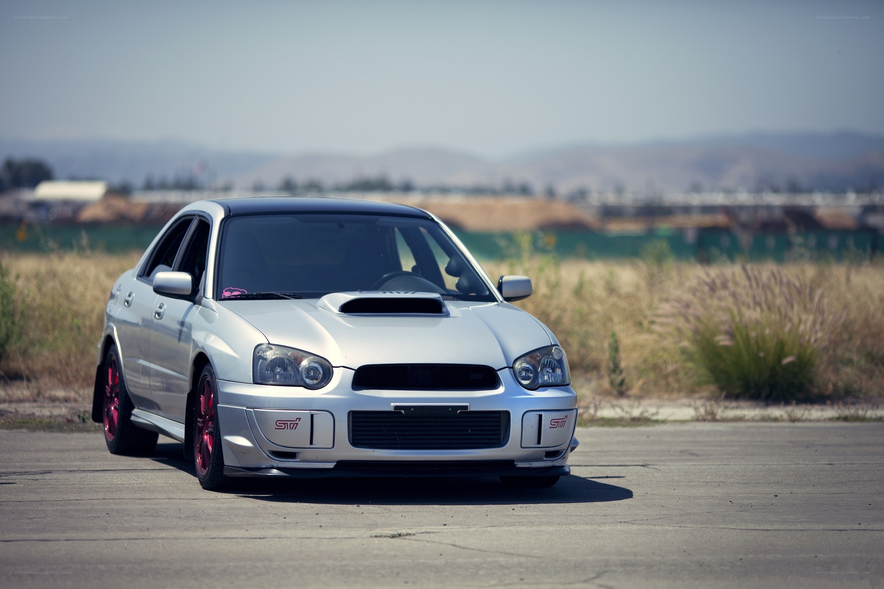silver subaru sti on pavement