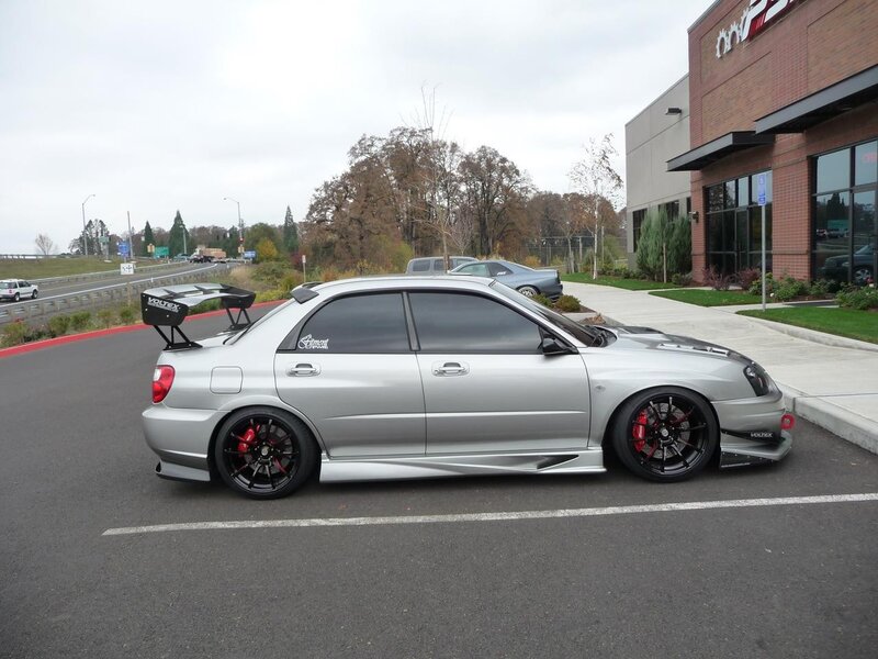 silver subaru with rear wing
