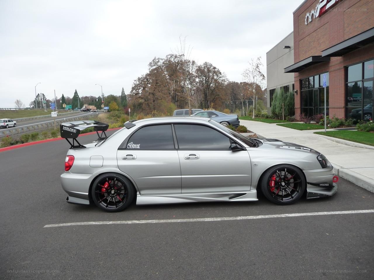 silver subaru with rear wing