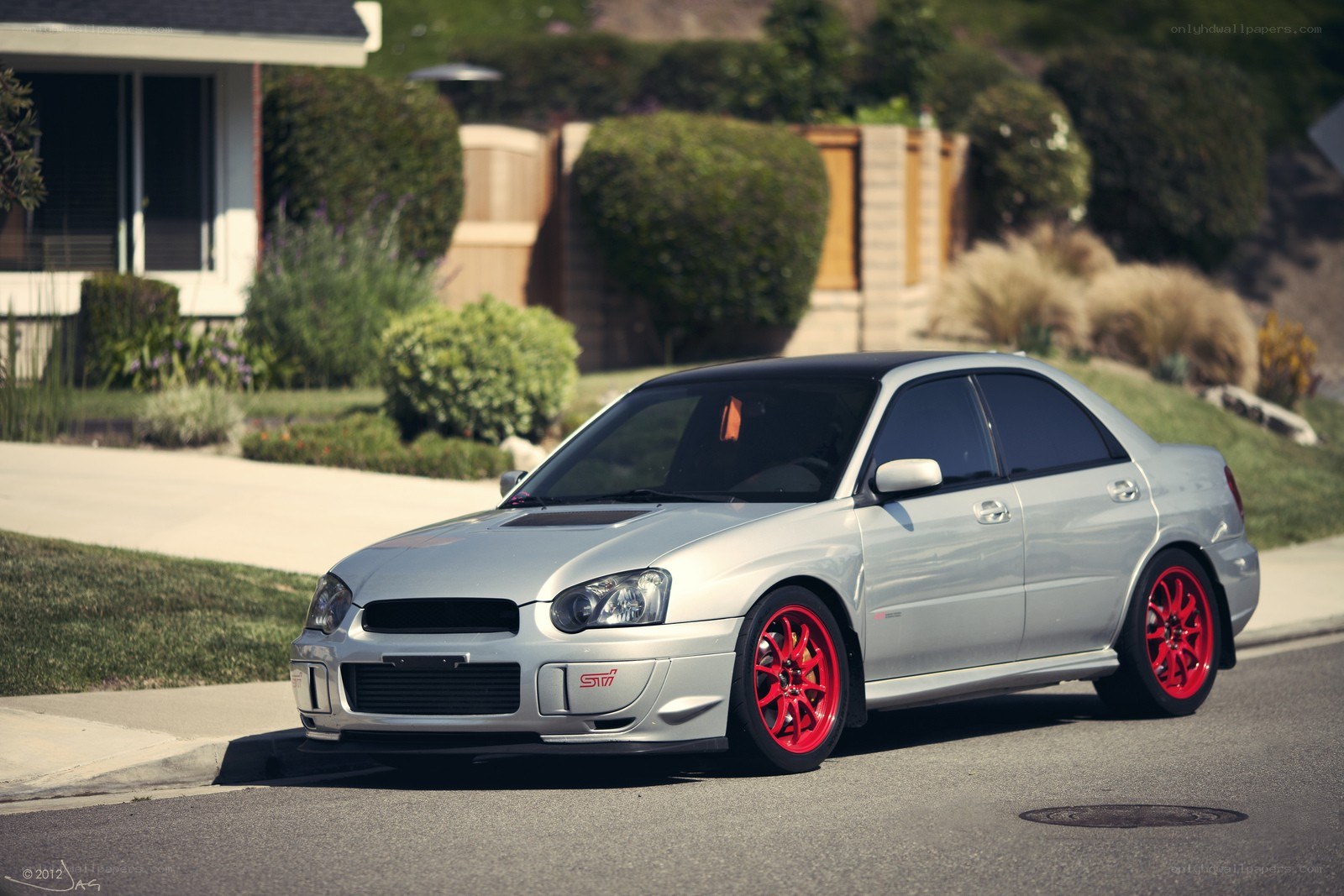 silver subaru with red wheels
