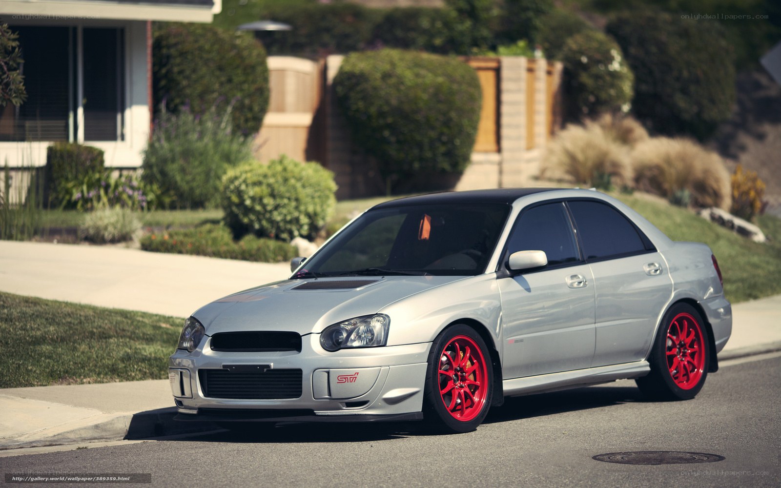 silver subaru with red wheels