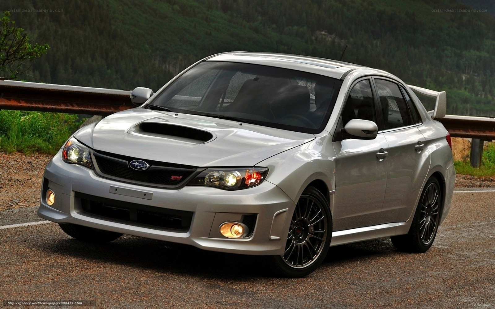 silver subaru wrx sti on mountain road