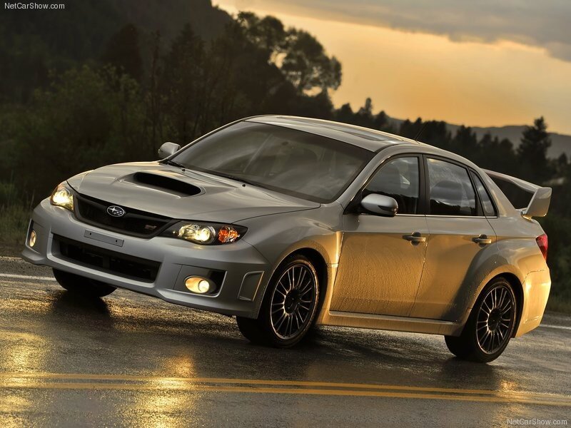 silver subaru wrx sti on wet road