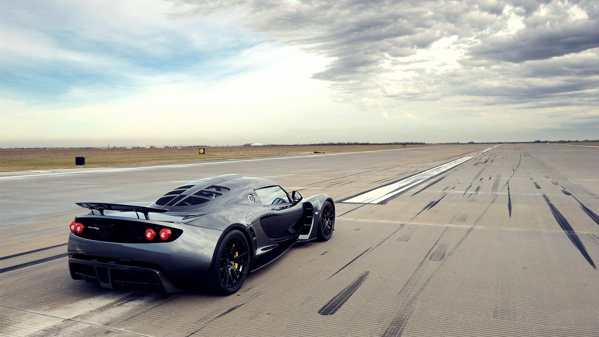 silver supercar on runway