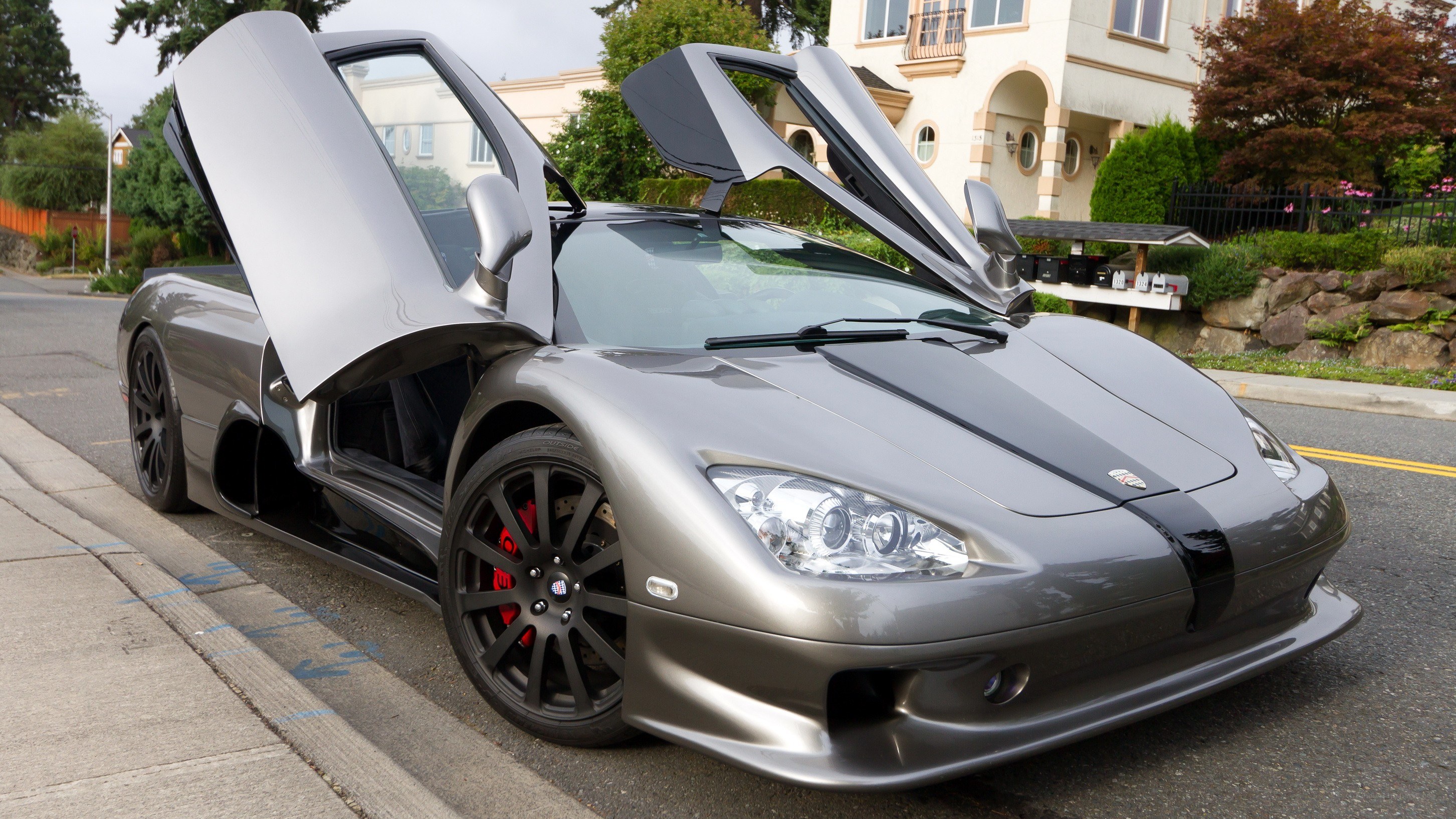 Silver supercar with open doors
