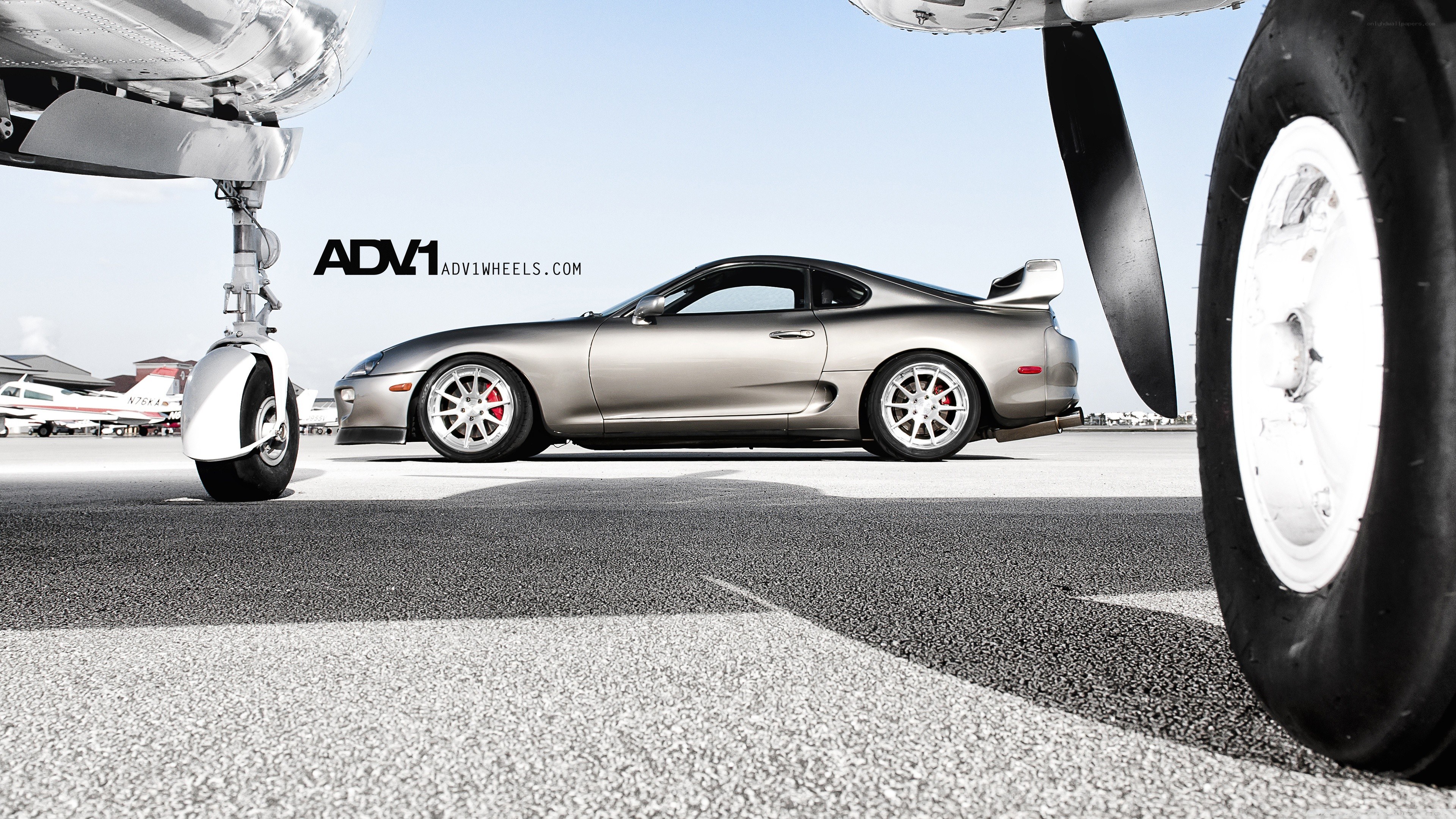 Silver Supra with aircraft