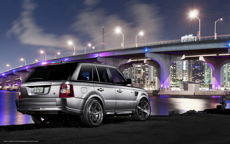 Silver SUV at Night by Bridge