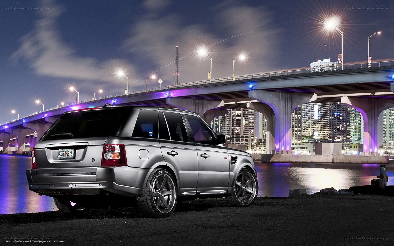 Silver SUV at Night by Bridge