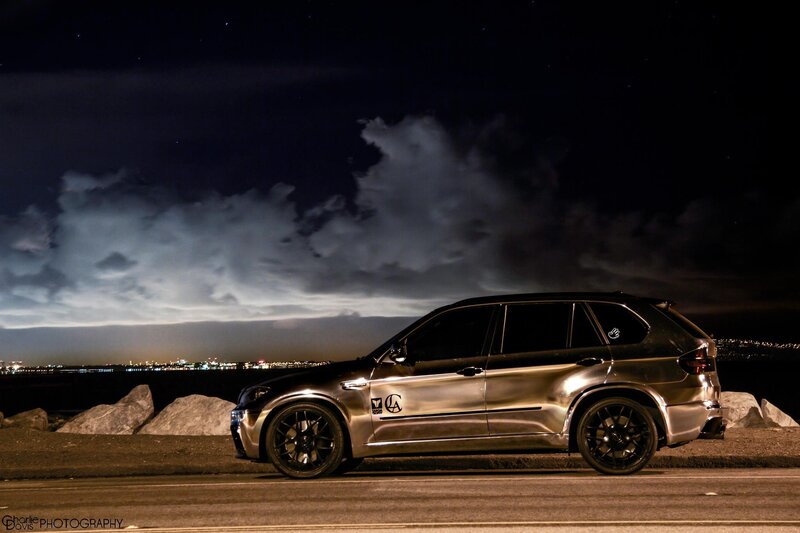 Silver SUV at night by the water