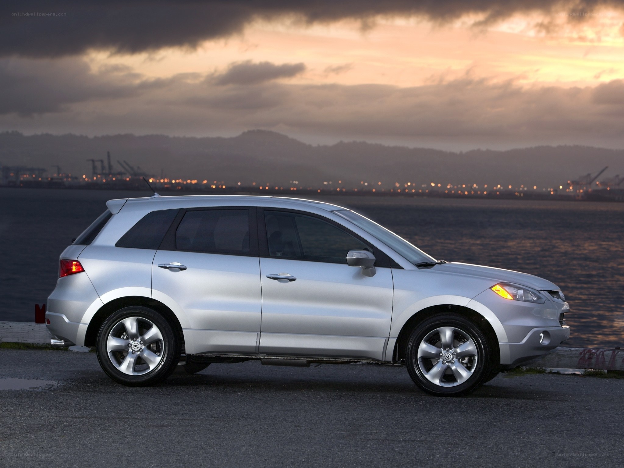 Silver SUV at sunset by the water