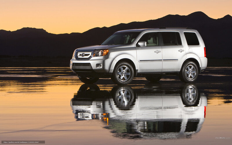 Silver SUV at sunset reflection