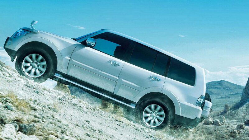 Silver SUV climbing rocky hill