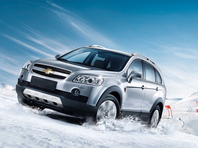 Silver SUV driving in snow