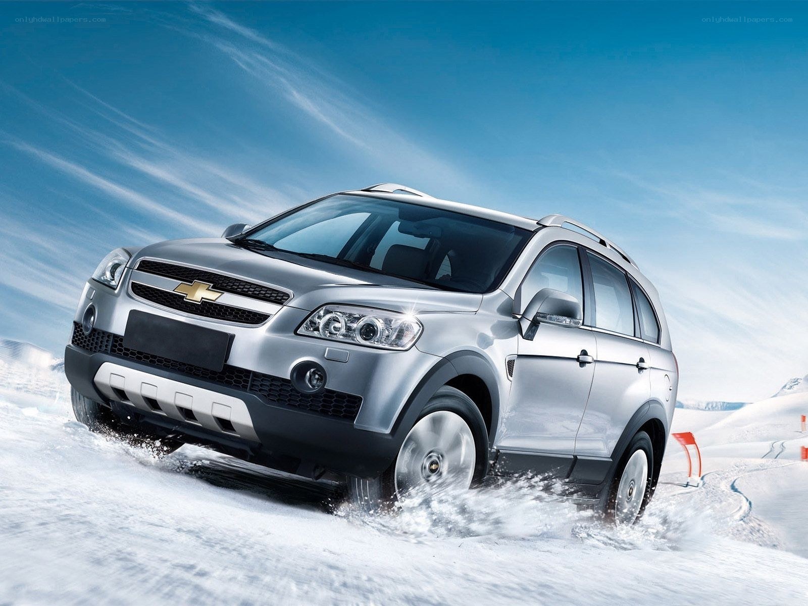 Silver SUV driving in snow