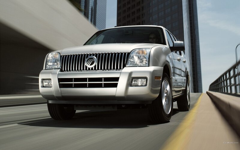 silver SUV driving on bridge