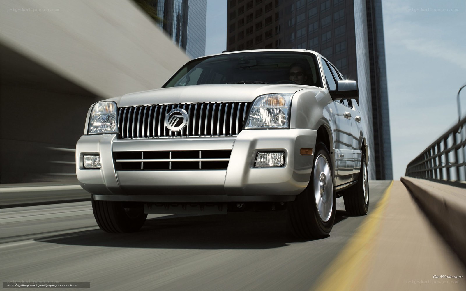 silver suv driving on bridge