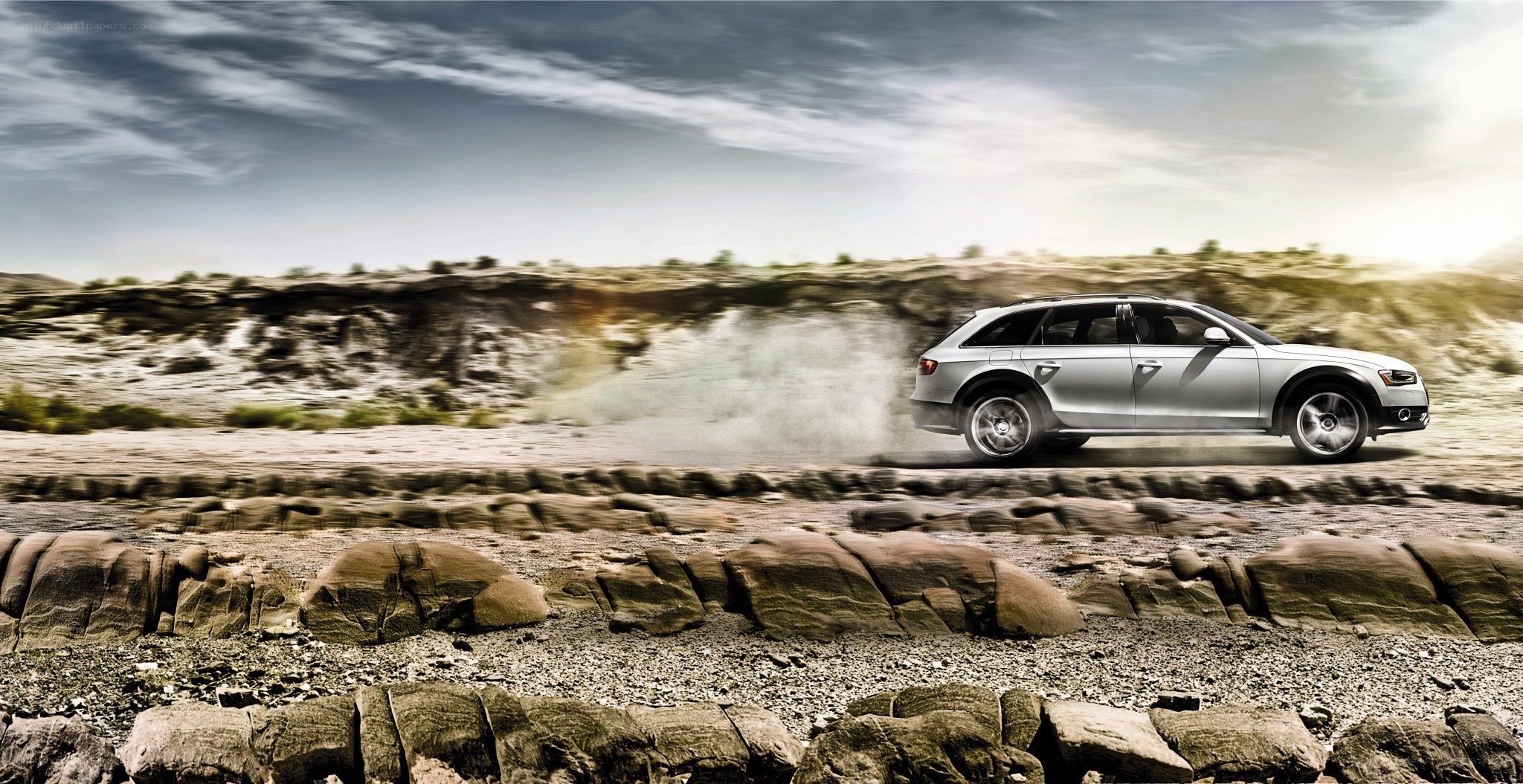 Silver SUV driving on dirt road