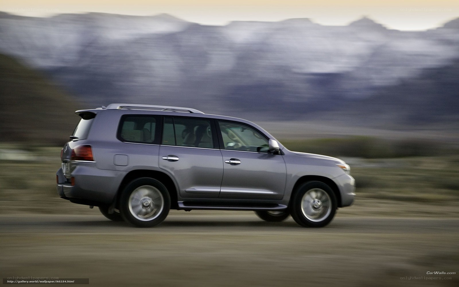silver suv driving on dirt road