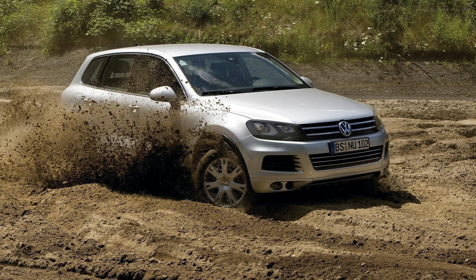 Silver SUV driving on dirt