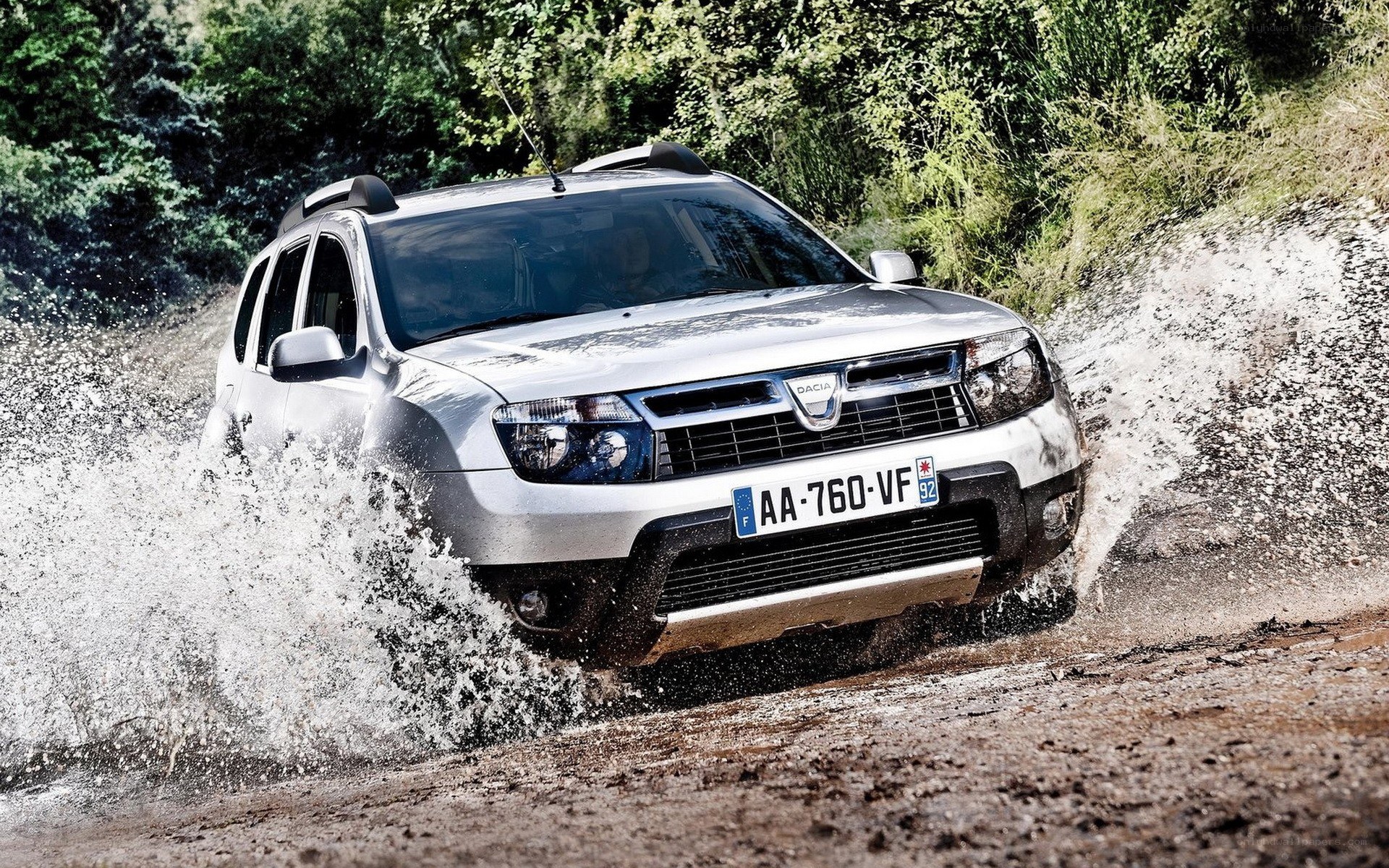 Silver SUV driving through mud
