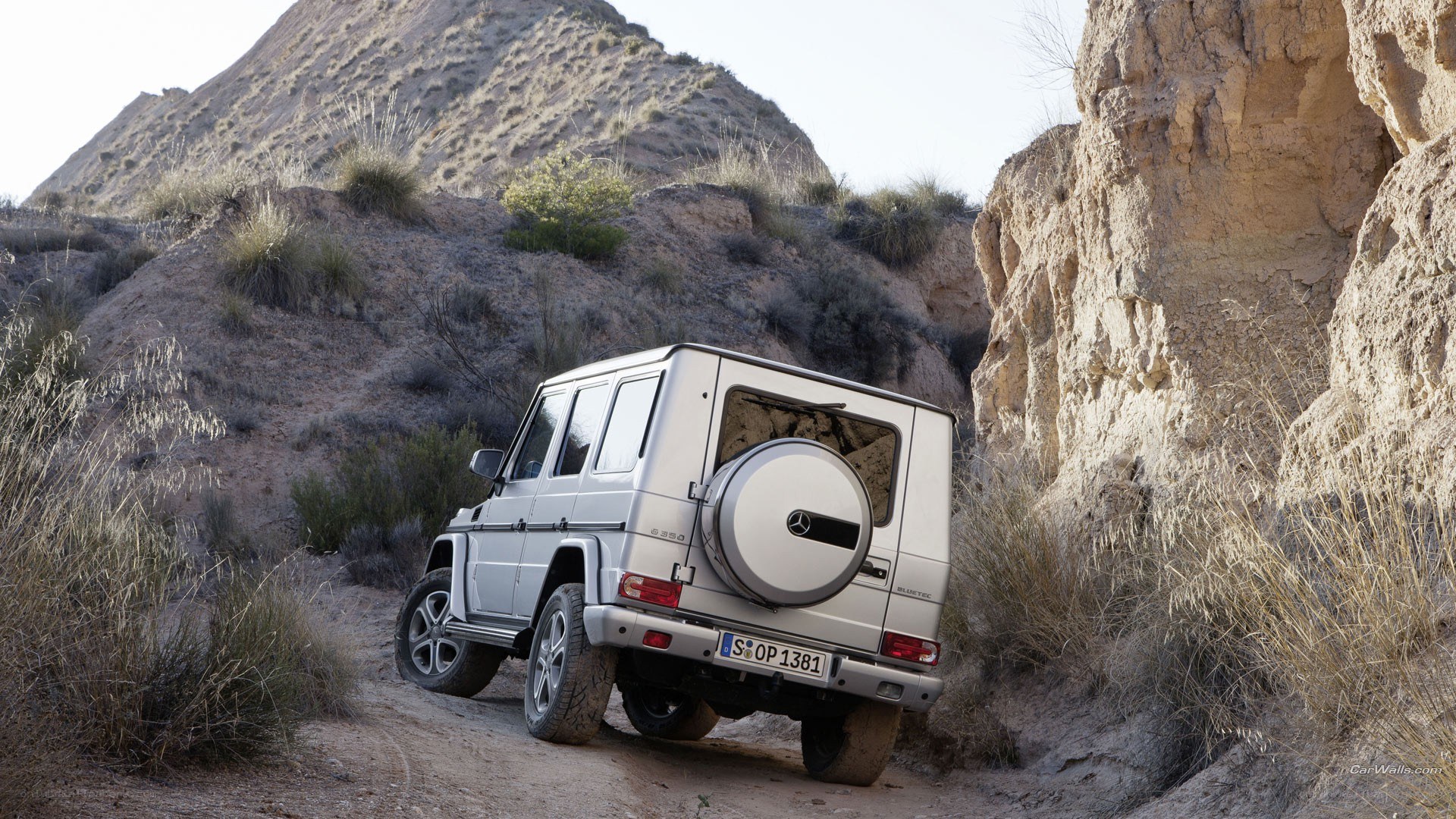 silver suv in desert canyon