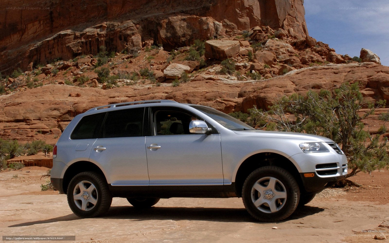 silver suv in desert canyon