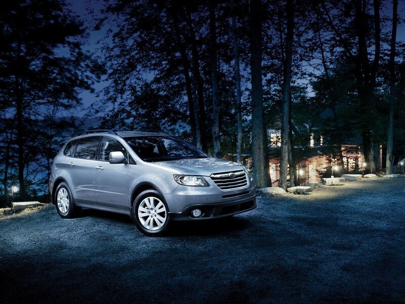 Silver SUV in forest at night
