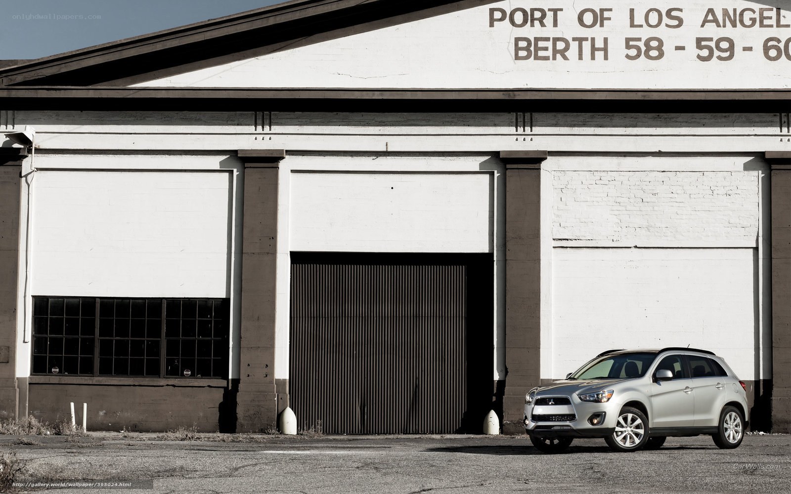 Silver SUV in front of warehouse