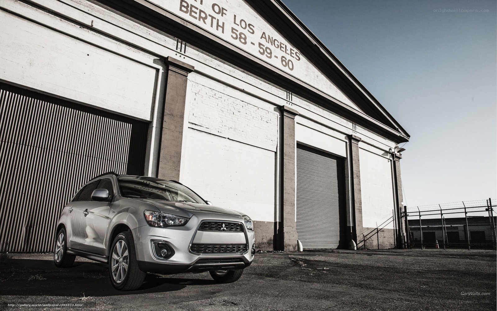 Silver SUV in front of warehouse