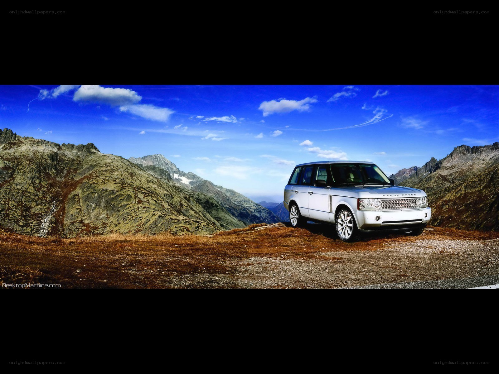 Silver SUV in mountain landscape