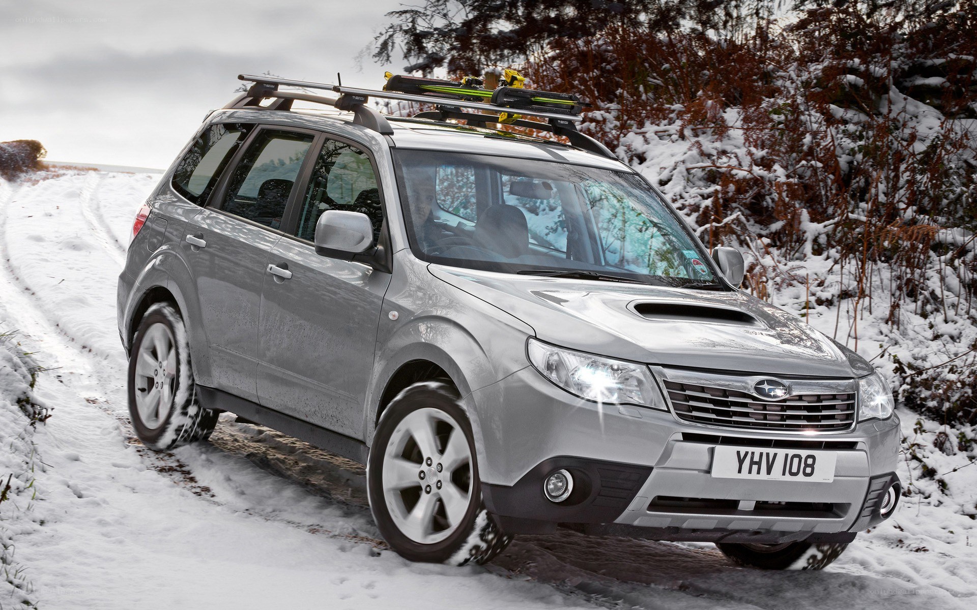 Silver SUV in snowy landscape
