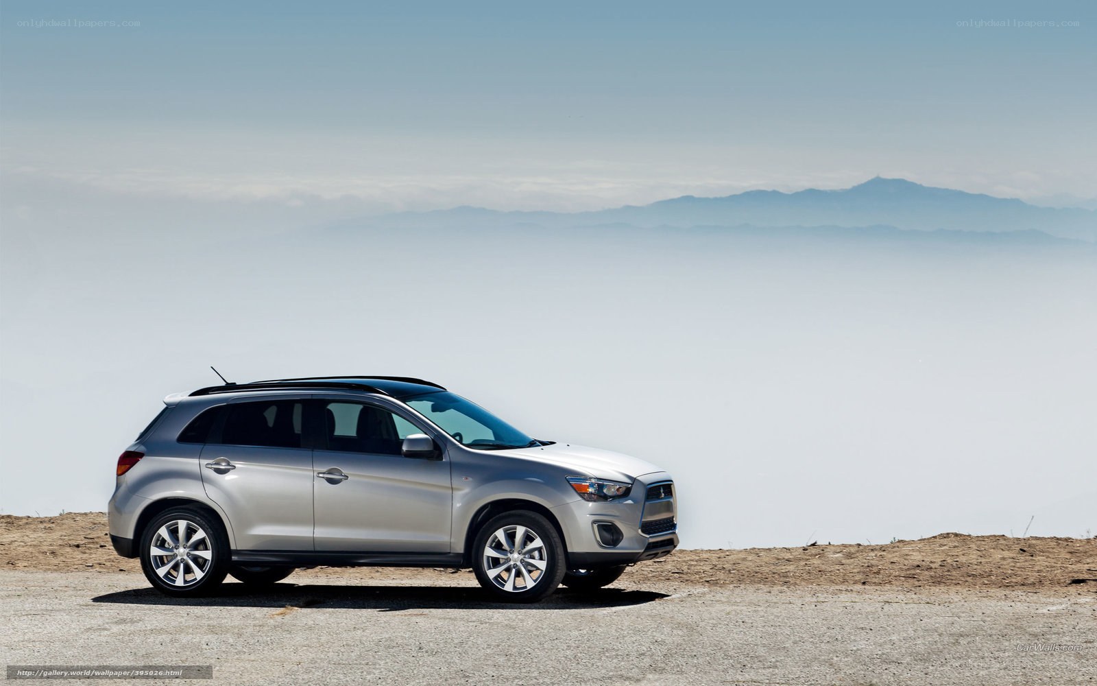 Silver SUV on a mountain overlook