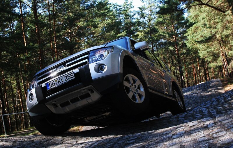 Silver SUV on cobblestone path