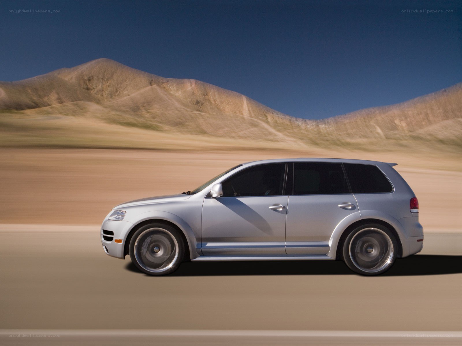 silver suv on desert road
