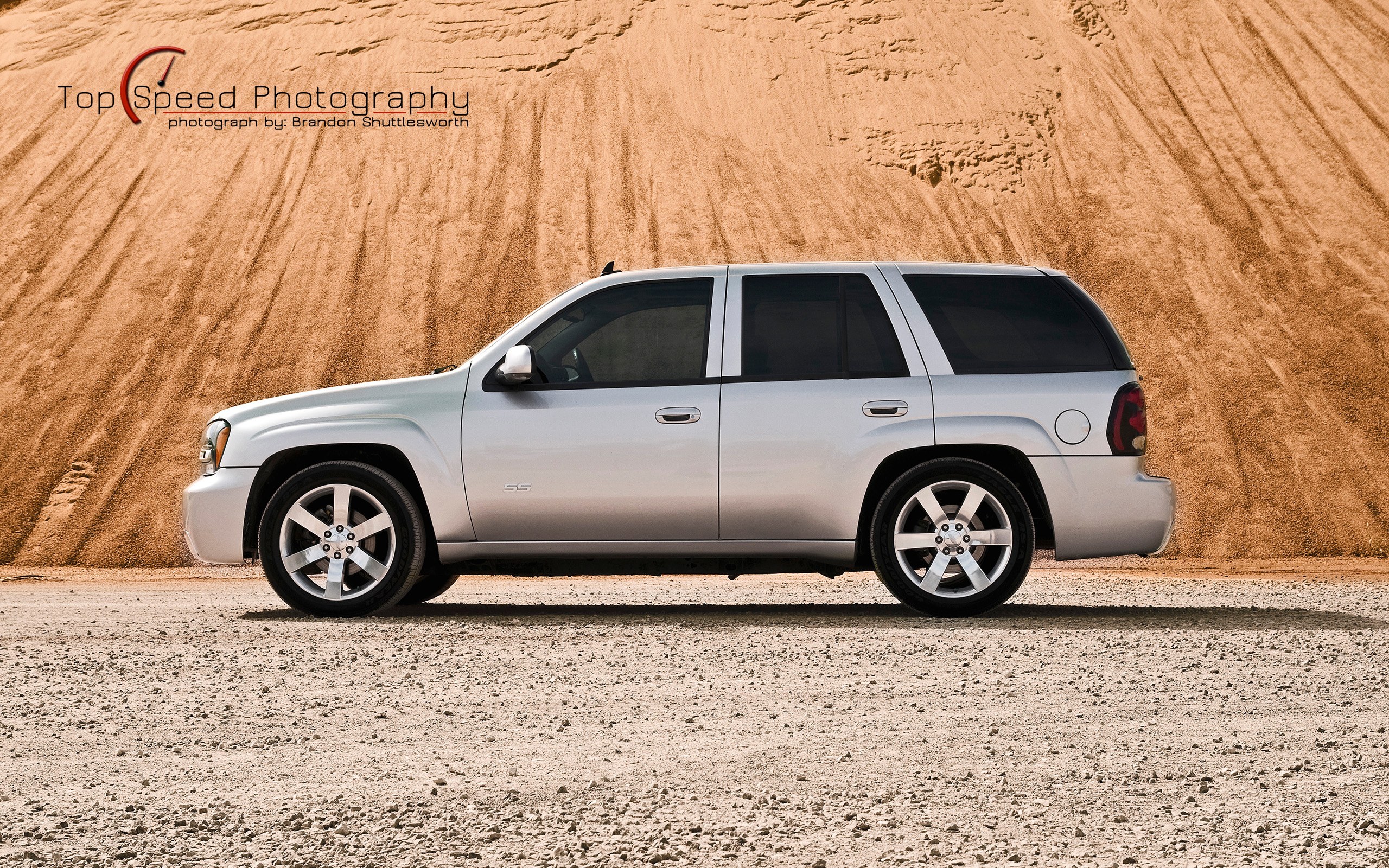 silver suv on gravel