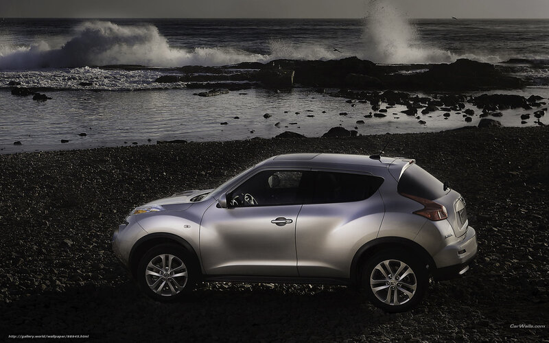 Silver SUV on rocky beach