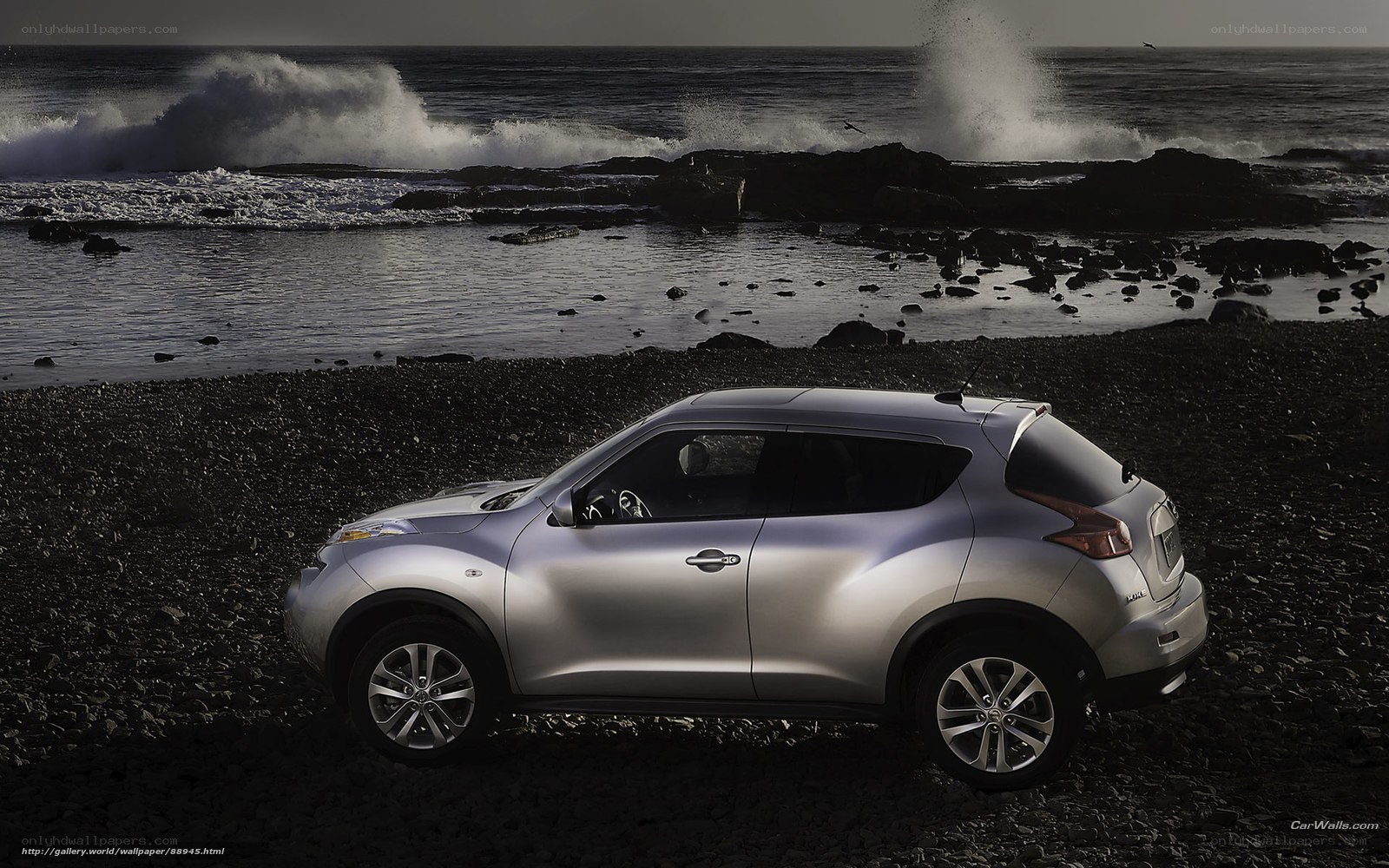 Silver SUV on rocky beach