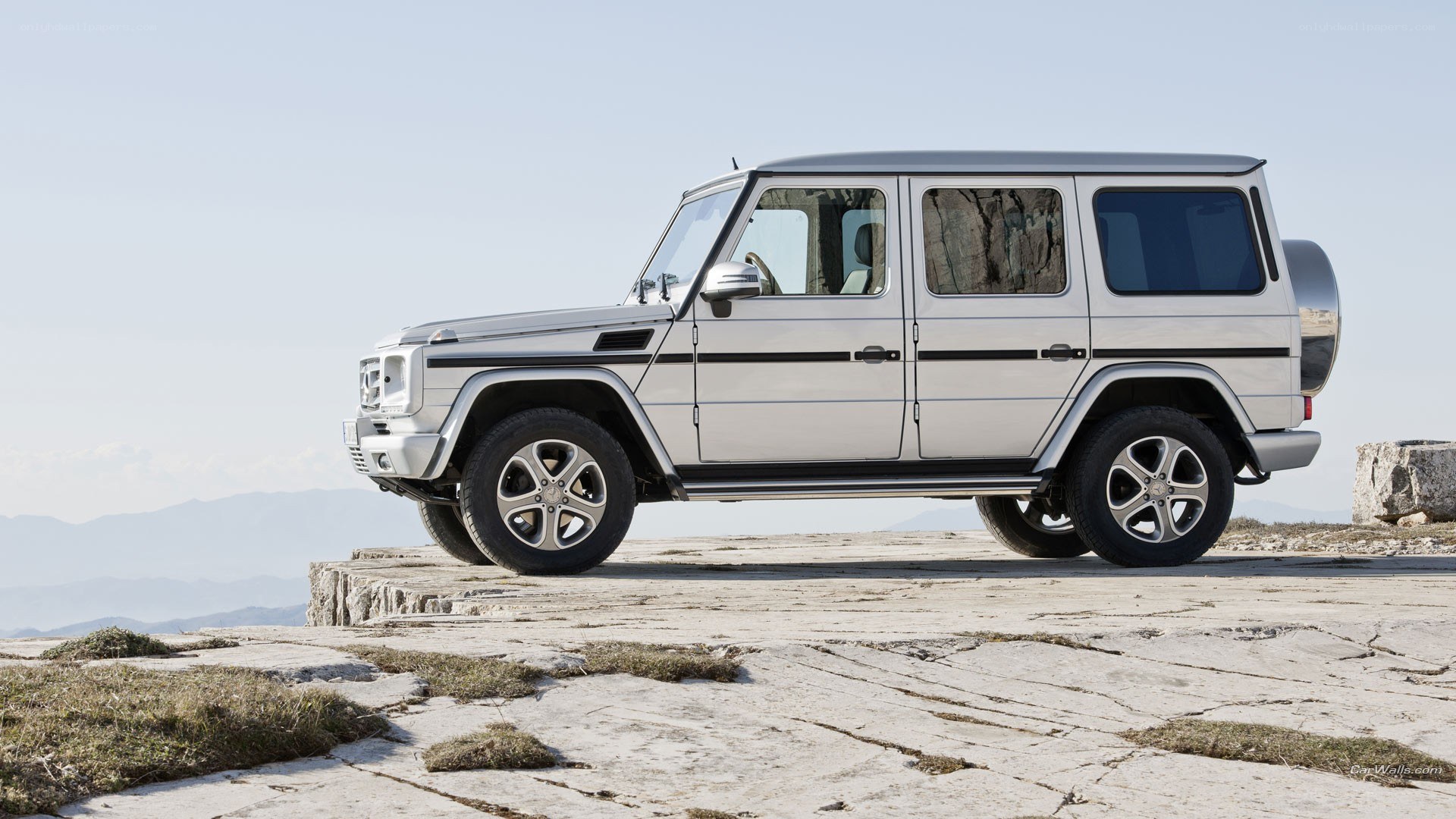 silver suv on rocky cliff