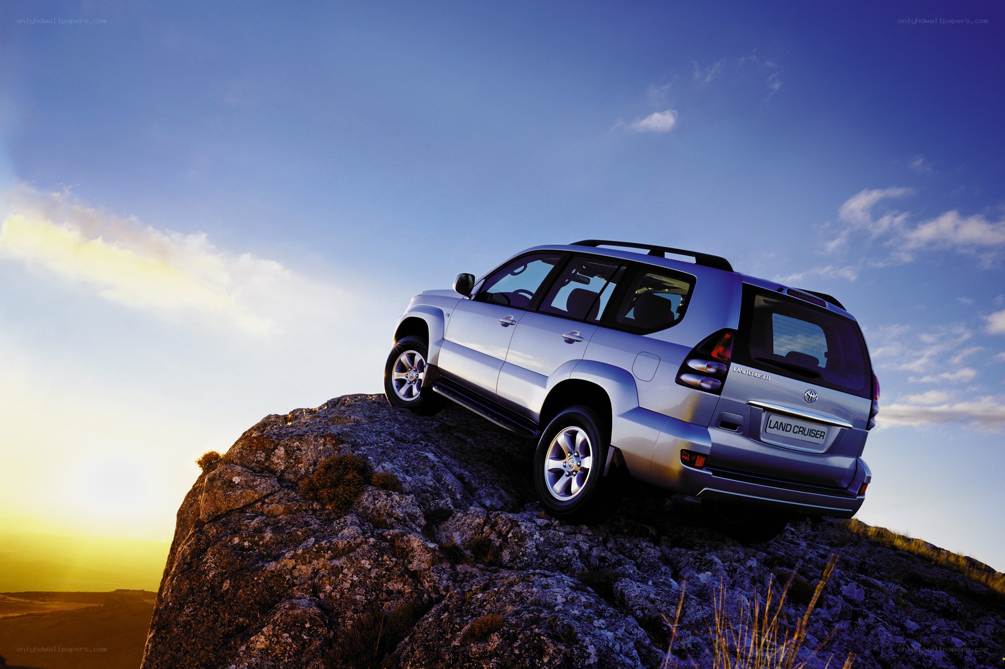 Silver SUV on rocky cliff