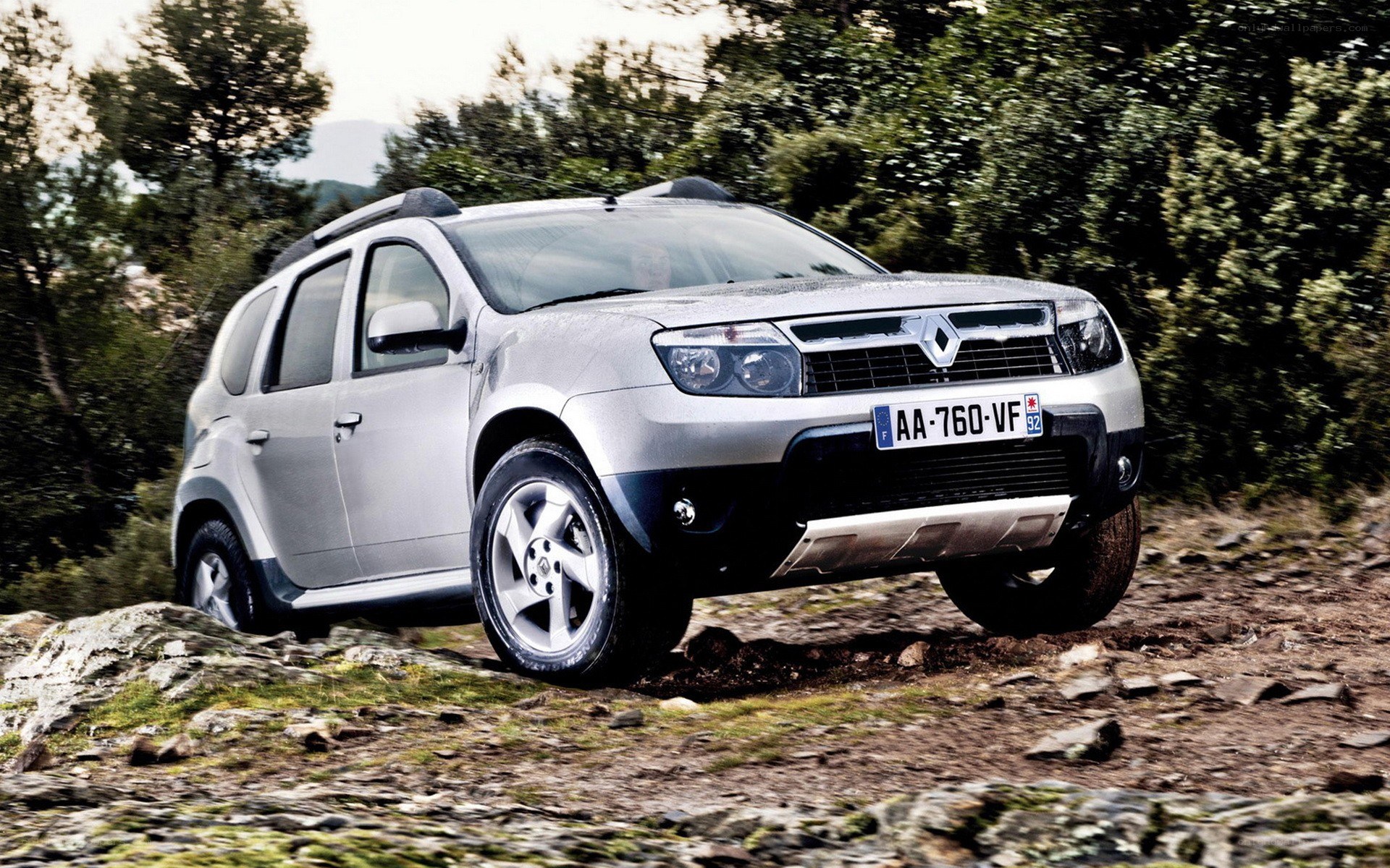 Silver SUV on rocky terrain
