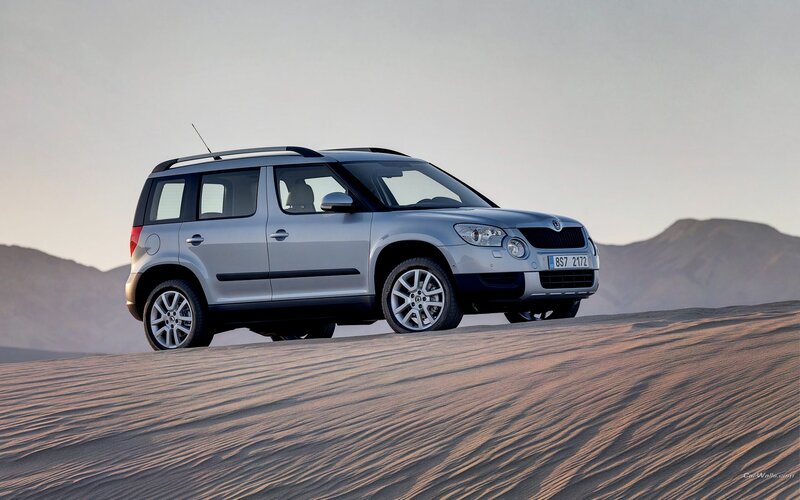 silver suv on sand dune